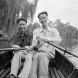Two men sitting in rowboat