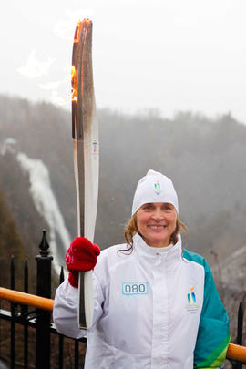 NEW- Day 35 Torchbearer 80 Odette Tremblay carrying the flame at Parch de la Chute Montmonrency i...