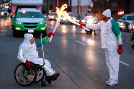 Day 52 Torchbearer 10 Clifton Agard passes the flame to Torchbearer 11 Chad Pilon in Hamilton, On...