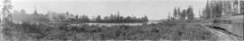 [View of the North Arm of the Fraser River showing two tugboats and log booms]