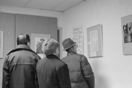 People looking at a historical photographs exhibit at the Chinese Cultural Centre Spring Festival