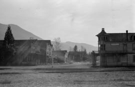 [Railroad tracks crossing main street in Slocan]